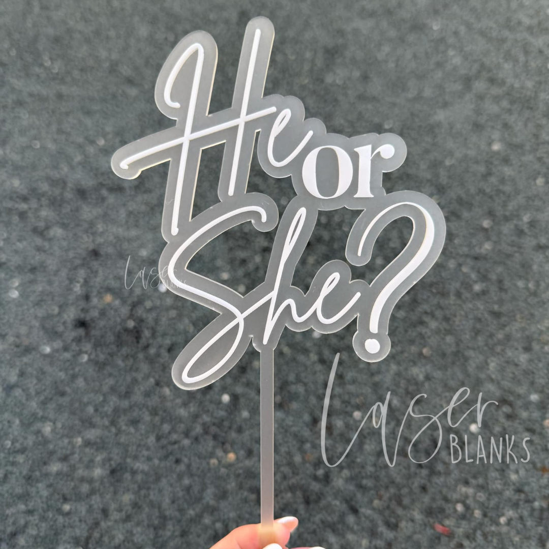 White script “He or She?” topper for gender reveal cakes