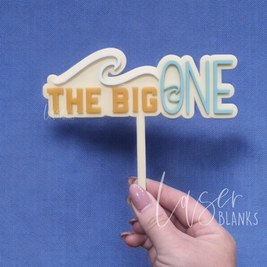 Surf-themed first birthday cake topper with “The Big ONE” in wave-style font
