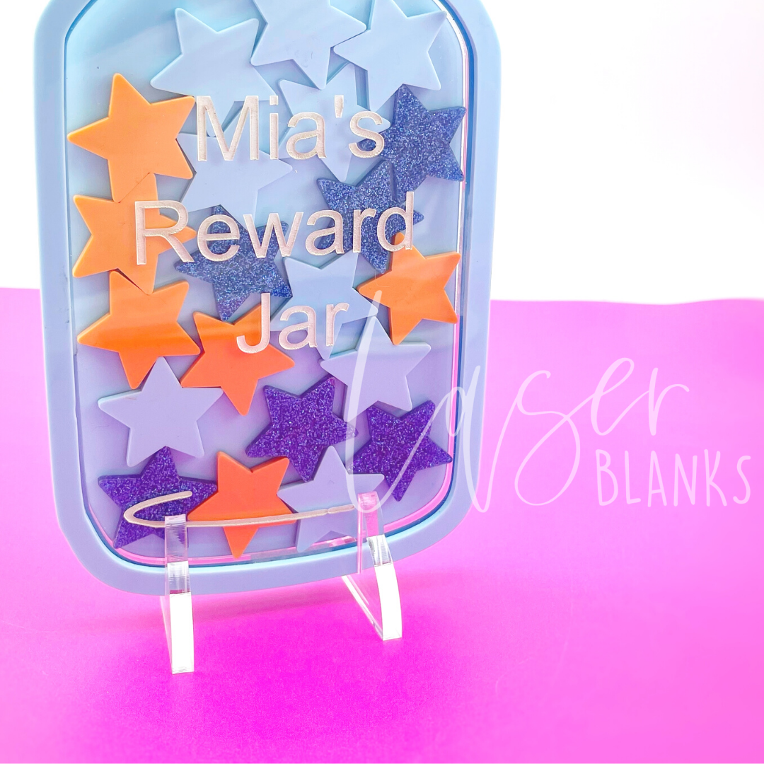 an acrylic reward jar standing on a table with an acrylic reward jar stand